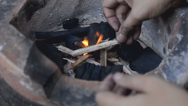 Woman hands do fire in the retro stove — Stock Video