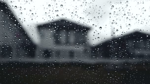 Raindrop overcast skies with rain fell from the car window glass view from the window near the village — Stock Video