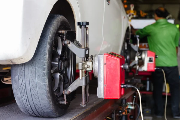 Close up shot of car wheel centering machine adjustment shallow — Stock Photo, Image