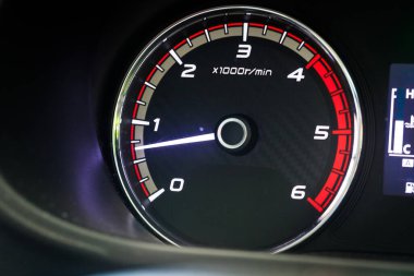 Dizel bir kamyonun torpido gözüne ve takometreye yakın çekim. Yuvarlak motor ölçerlerine net bir şekilde odaklanarak, bir iş aracının gücünü ve dayanıklılığını temsil eder..