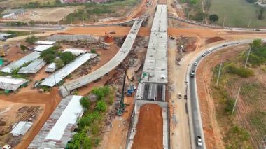 Kırsal kesimdeki bir yol kesişiminde, inşaat mühendisliği, altyapı geliştirme ve ulaşım projelerini gösteren hava aracı görüntüleri