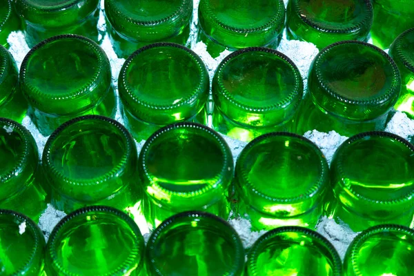 Green bottles in white wall abstract background