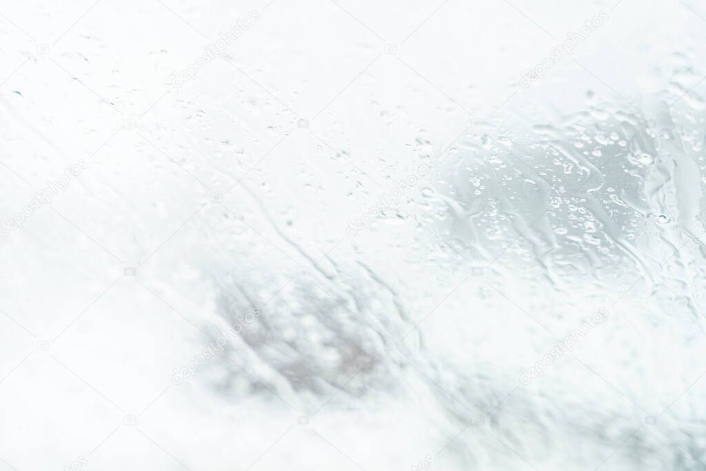 Blur the silhouette of the car on the window with raindrops