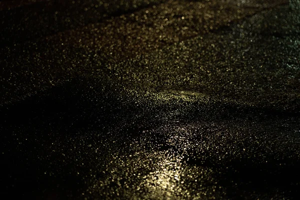 Car headlights on a wet road