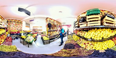 Batumi, Georgia - March 7, 2021: 360 VR Man taking pictures in a fruit shop clipart