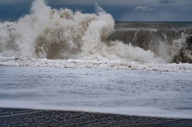 Bulutlu bir gökyüzüne karşı denizde fırtına dalgaları