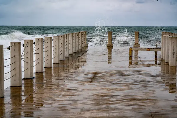 waves roll on the pier during a storm