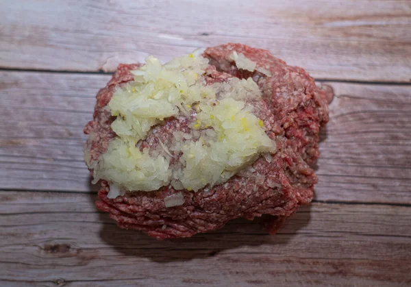 Carne Picada Con Una Tapa Cebolla Yace Sobre Mesa — Foto de Stock