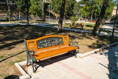 Wooden brown bench in the park