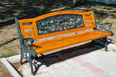 Wooden brown bench in the park