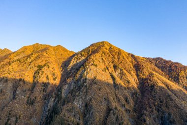 Brown mountain in the clouds view from a drone