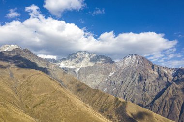 Brown mountain in the clouds view from a drone