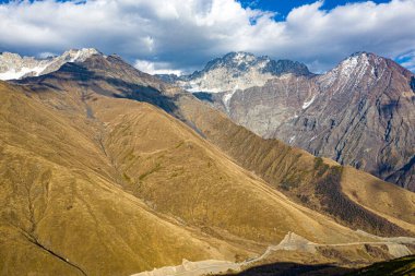 Brown mountain in the clouds view from a drone