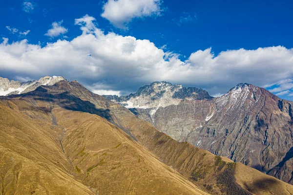 Brown mountain in the clouds view from a drone