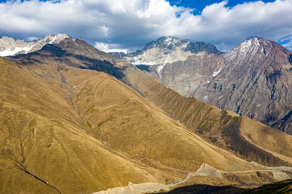 Brown mountain in the clouds view from a drone