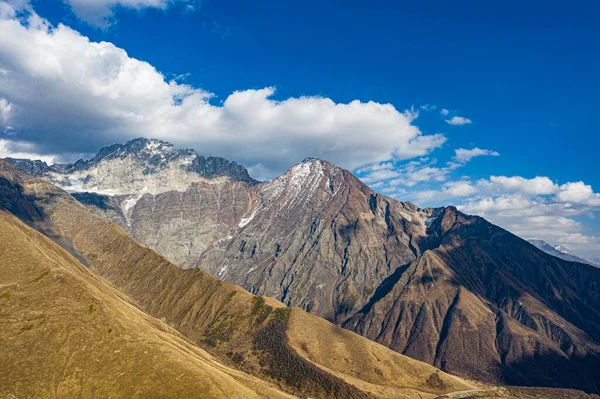 Brown mountain in the clouds view from a drone