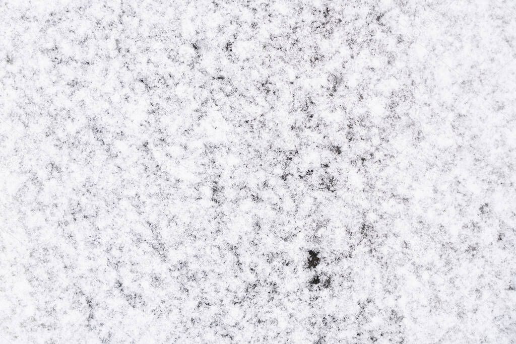 Abstract background in the form of snow on the asphalt