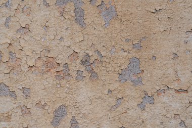 Duvardaki kahverengi alçı soyut bir arkaplan olarak çatlaklara yapışmış.