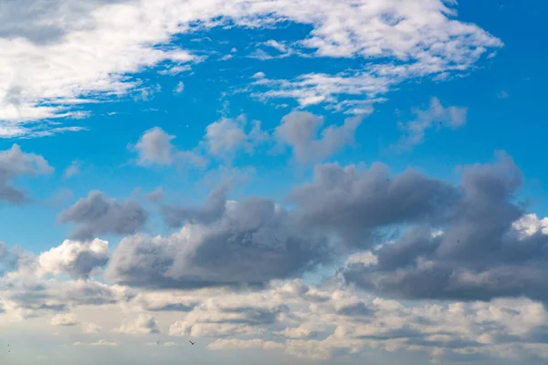 Gray and white clouds on blue sky