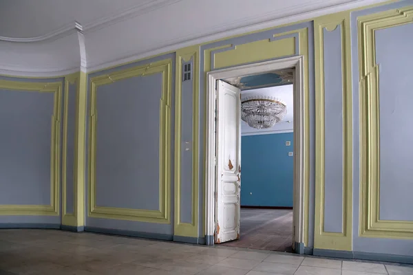 The door and the beautiful interior of an old abandoned manor.