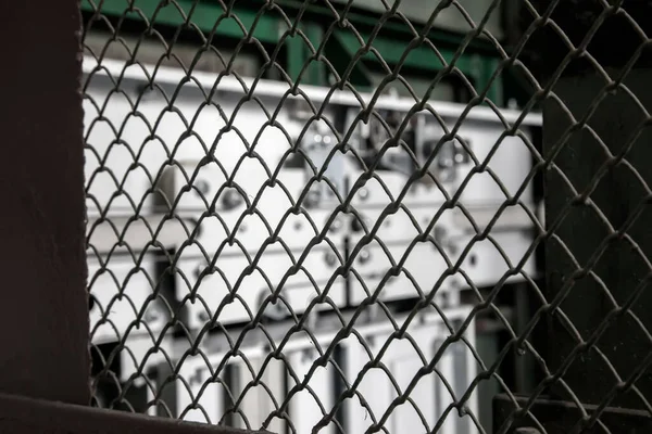 The view through the grating of the elevator shaft. Old elevator in an abandoned house. Metal mechanisms.