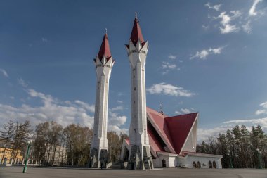 Mavi gökyüzüne karşı iki kulesi olan güzel bir cami. Parktaki camii. Güneşli bir akşam. Güzel bir akşam sıcacık ışığı. Güzel mimari.
