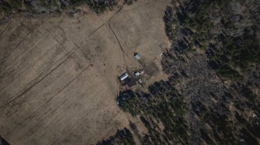 Yukarıdan güzel ve renkli bir doğa. Tarlalar ve ormanlar. Güneşli bir gün. Ağaçlar ve kuru otlar.