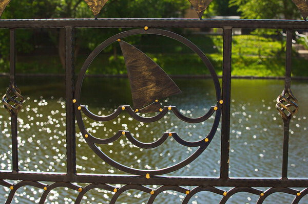 Forged fence of the city pond.