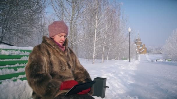 Amazed wow woman looking a tablet application in a snowy mountain on vacations