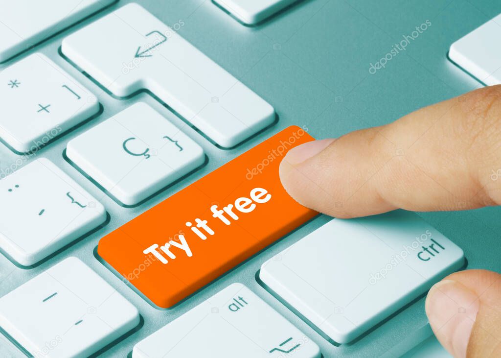 Try it free Written on Orange Key of Metallic Keyboard. Finger pressing key.