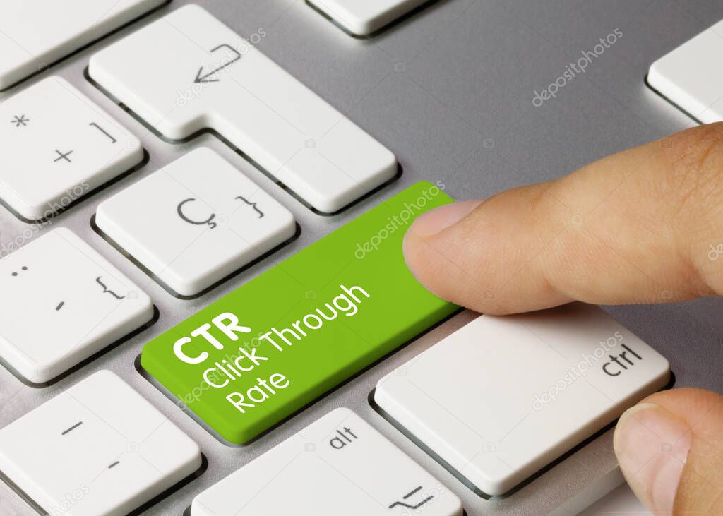 CTR Click Through Rate Written on Green Key of Metallic Keyboard. Finger pressing key.