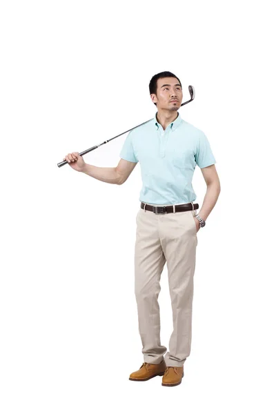 Jongeman in pak en golfen — Stockfoto