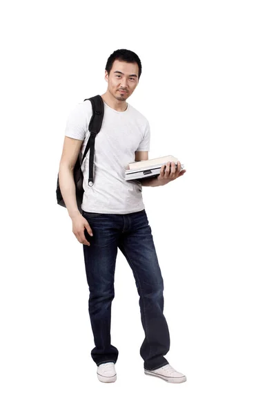 Um estudante universitário masculino estava segurando um livro — Fotografia de Stock