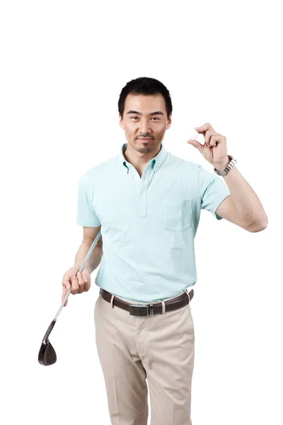 Genç adam takım elbise giyip golf oynuyor. — Stok fotoğraf