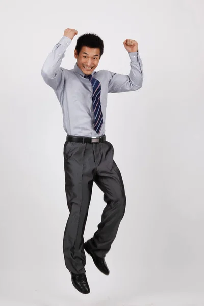Um homem de negócios saltando em uma camisa — Fotografia de Stock