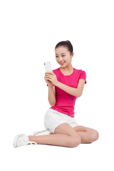 Young woman photographing herself with mobile phone — Stock Photo, Image