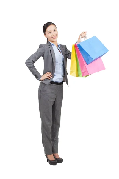 Una joven feliz sosteniendo bolsas de compras —  Fotos de Stock