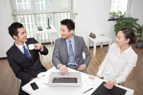 Group of business people chatting in office