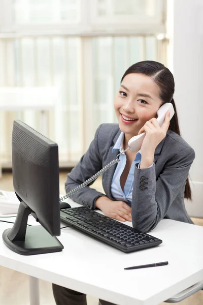 A Business woman talking on telephone Stock Picture