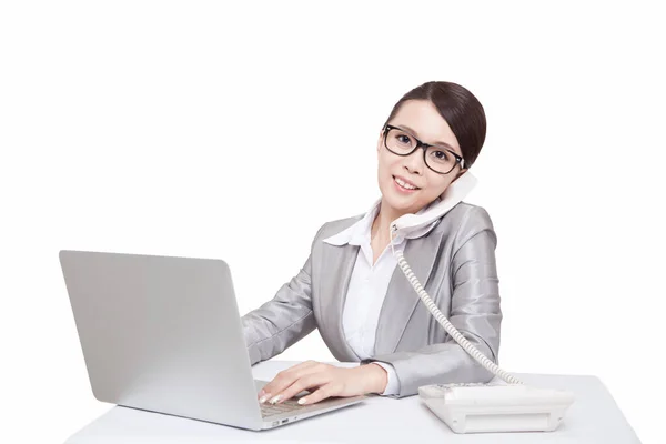 Portrait of young businesswoman talking on telephone at desk — Stock Photo, Image