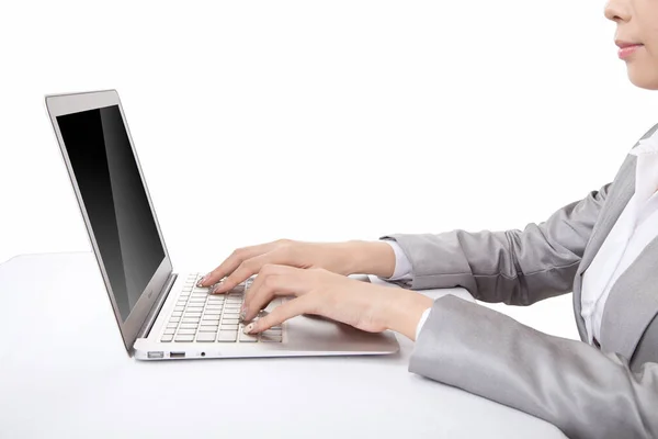 Portrait of young businesswoman using laptop,side view,close-up — Stock Photo, Image