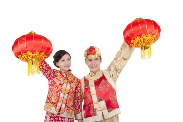 Jovem casal em ternos Tang pagando chamada de Ano Novo segurando lanternas vermelhas — Fotografia de Stock