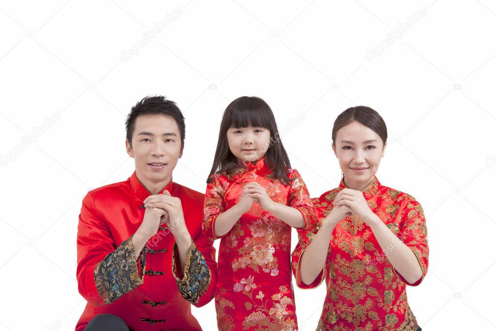 Portrait of daughter with parents in Tang suits paying New Year call 