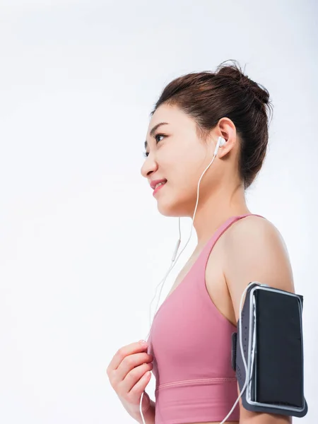 Young women in sports vests relax by listening to music