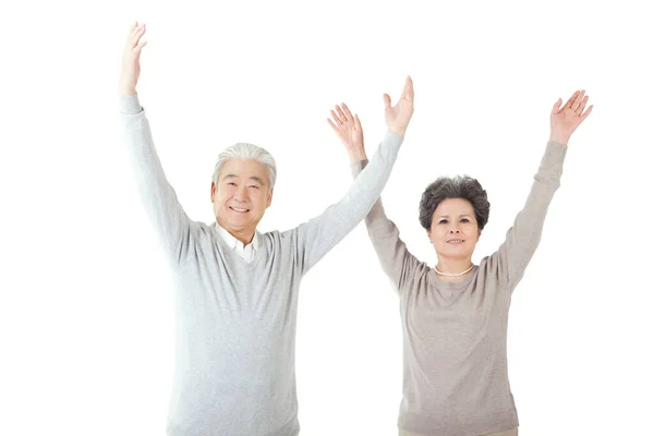 Oriental old couple with arms upraised — Stock Photo, Image