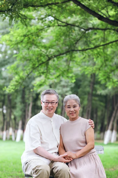 Glada gamla par sitter på stolar i utomhus park — Stockfoto