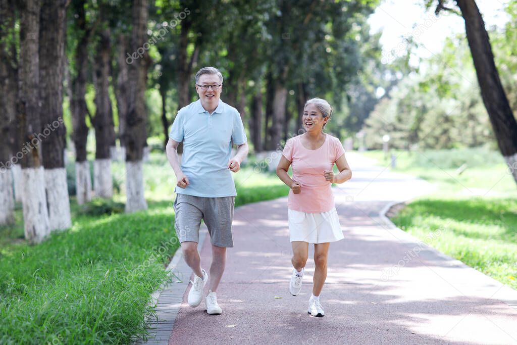 Old couple jogging in outdoor park