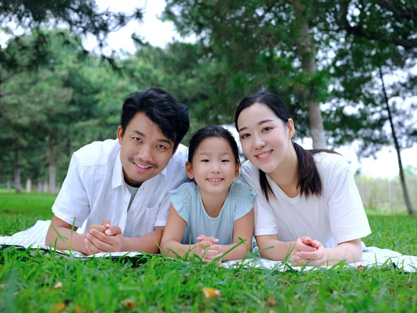 Famiglia felice di tre persone che giocano nel parco — Foto Stock