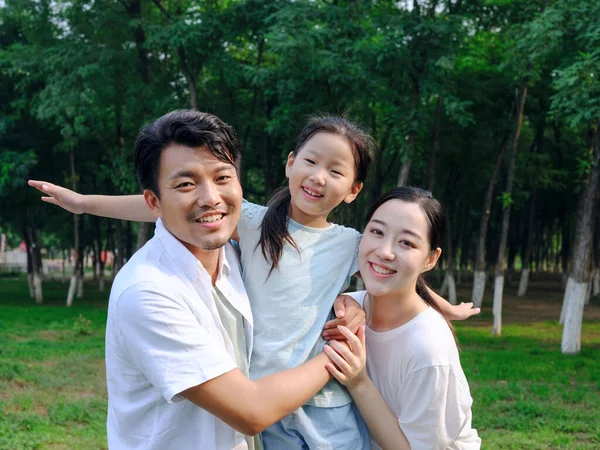 Familia feliz de tres jugando en el parque —  Fotos de Stock