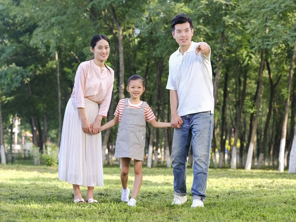 Happy family of three playing in the park — Stock Photo, Image
